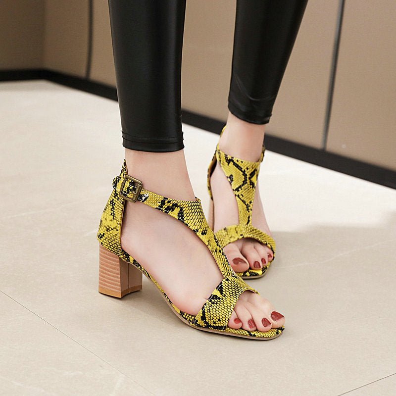 Snakeskin high-heeled chunky sandals.