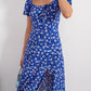 Robe d’été élégante à imprimé floral, manches courtes, épaules dénudées. Idéale pour les soirées et événements.