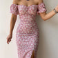 Robe d’été élégante à imprimé floral, manches courtes, épaules dénudées. Idéale pour les soirées et événements.