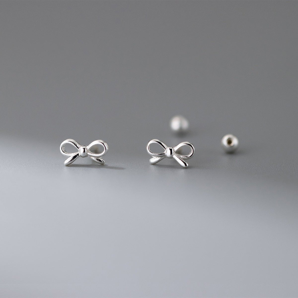 Fashion Hollowed-out Bowknot Thread Stud Earrings.